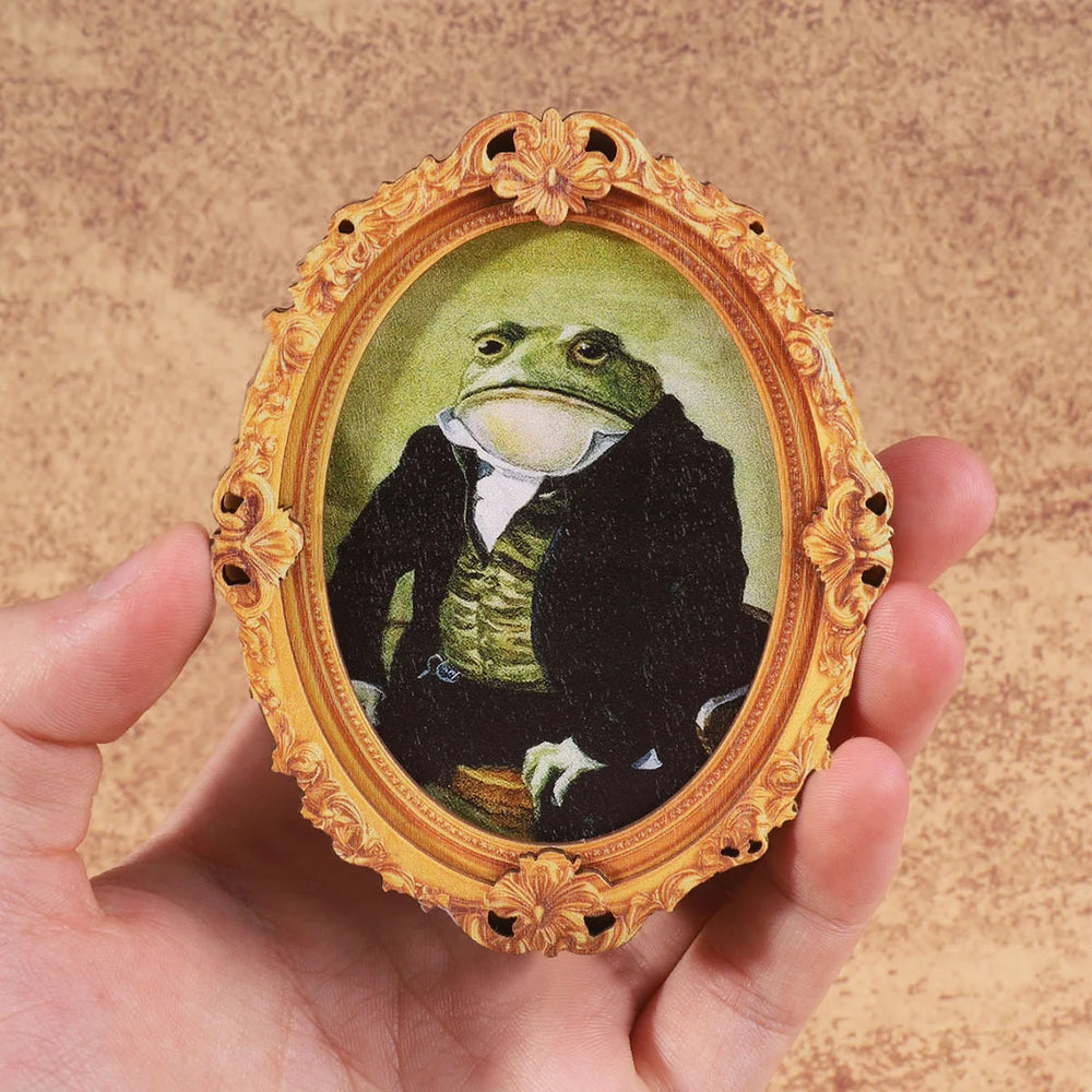 The frame magnet held in a hand to show the scale