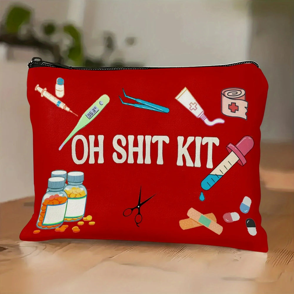 Red zip pouch printed with cartoon medical supplies and the words OH SHIT KIT, standing on a wooden table
