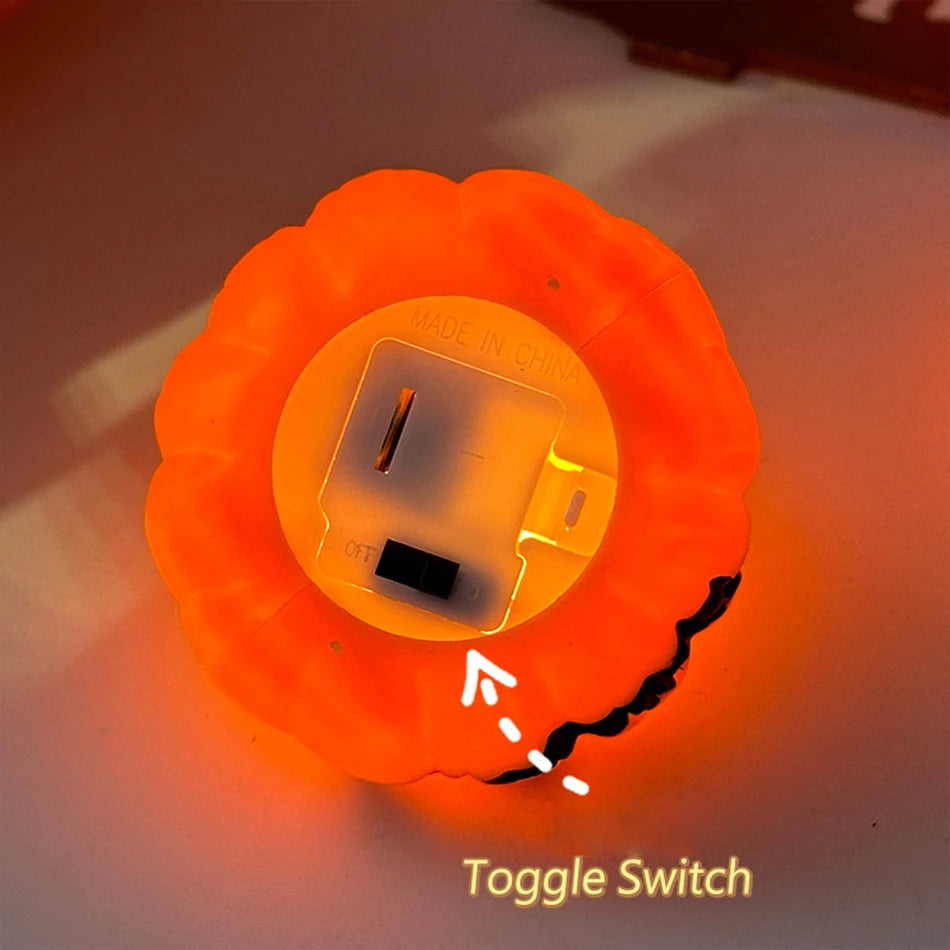 The underside of a pumpkin tealight showing the toggle switch