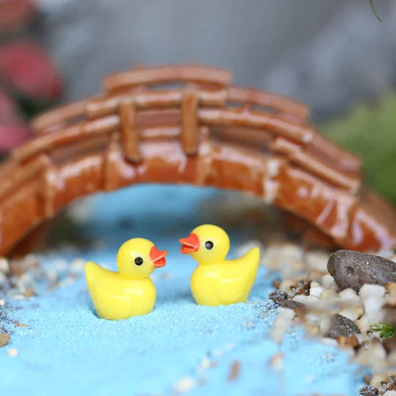 Two ducks on blue sand under a miniature brick bridge - the bridge is not included