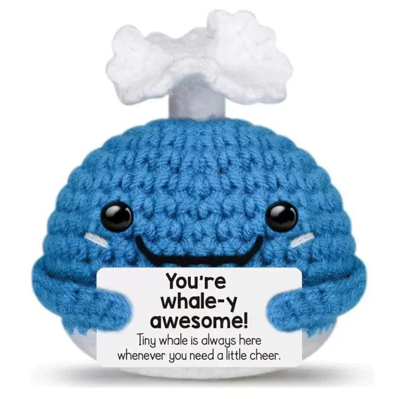 Crochet positive affirmation doll holding an encouragement card