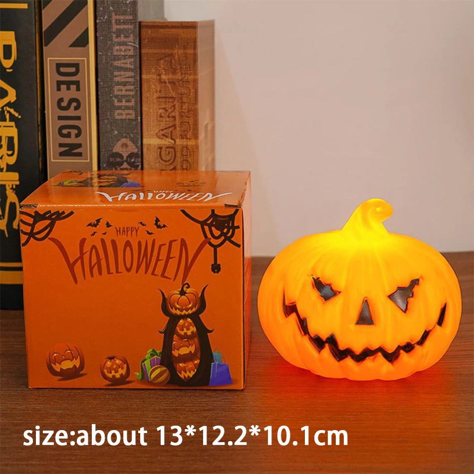 Large Single: the bigger lit pumpkin lantern beside its box, about 13 x 12.2 x 10.1 cm