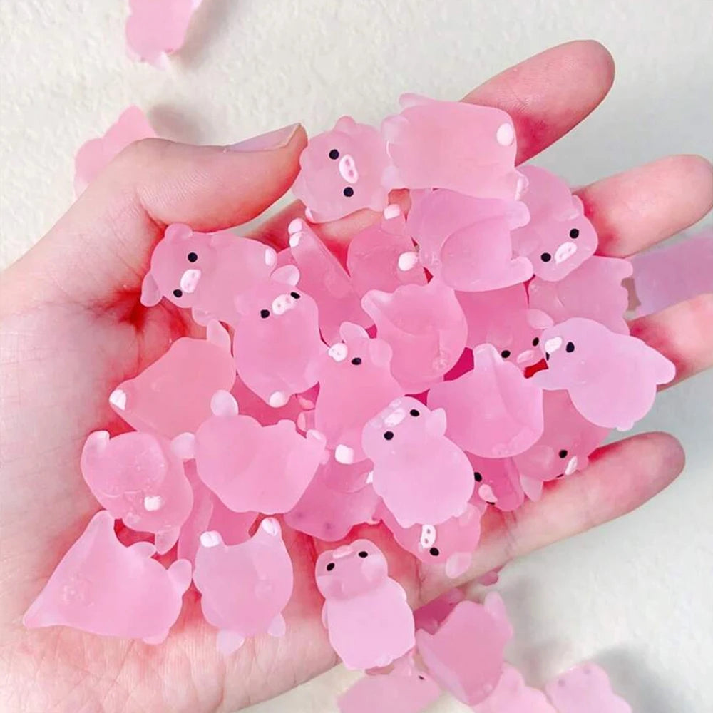 Palm full of the mini pink pigs