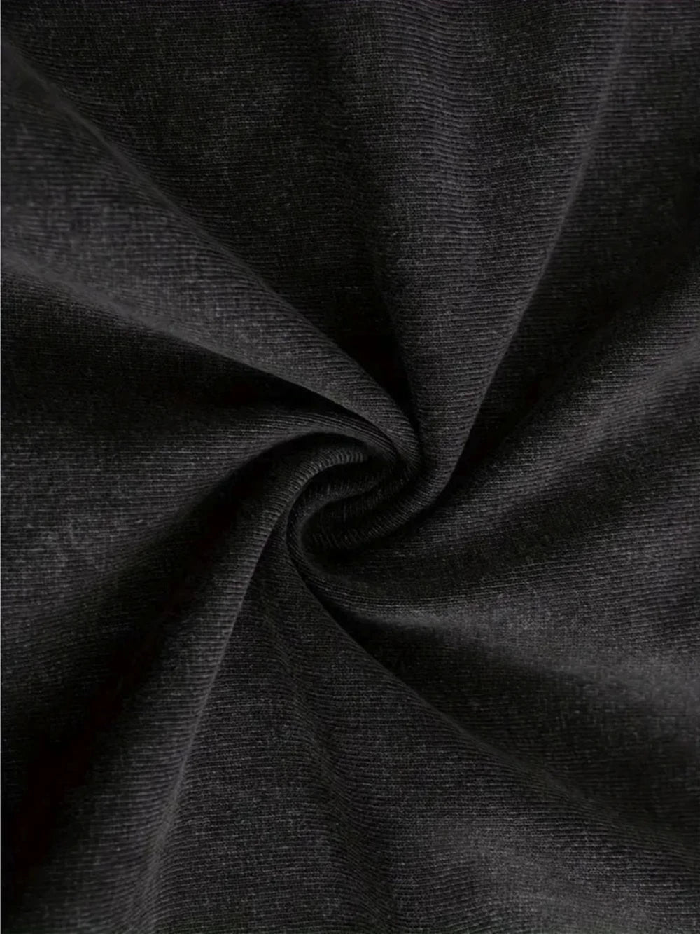 Close-up of the knit fabric surface, twisted to show the faded black finish