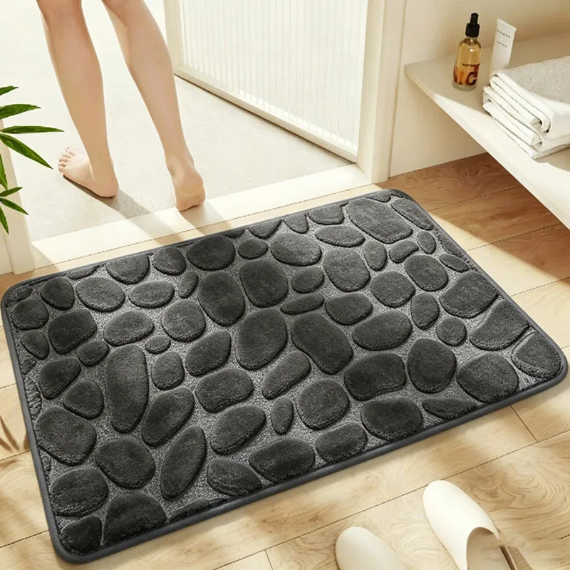 Dark Grey pebble-embossed bath mat on a bathroom floor