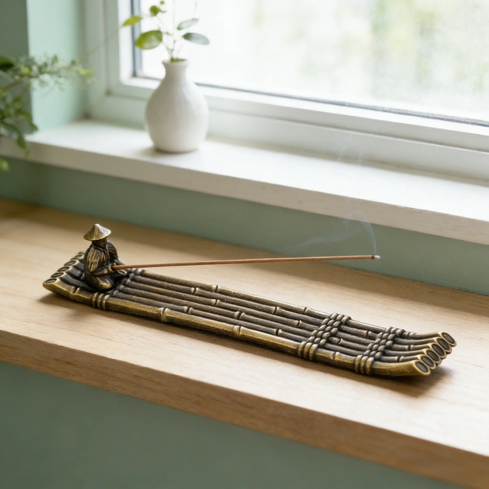 The raft holder on a windowsill beside a vase