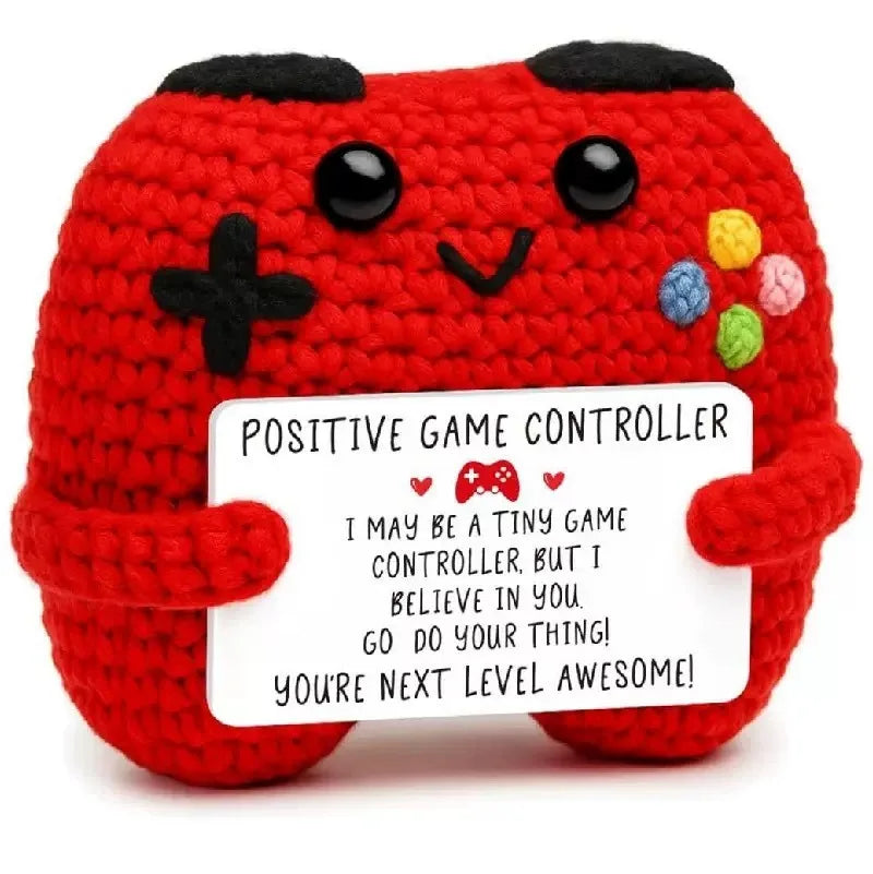 Crochet positive affirmation doll holding an encouragement card