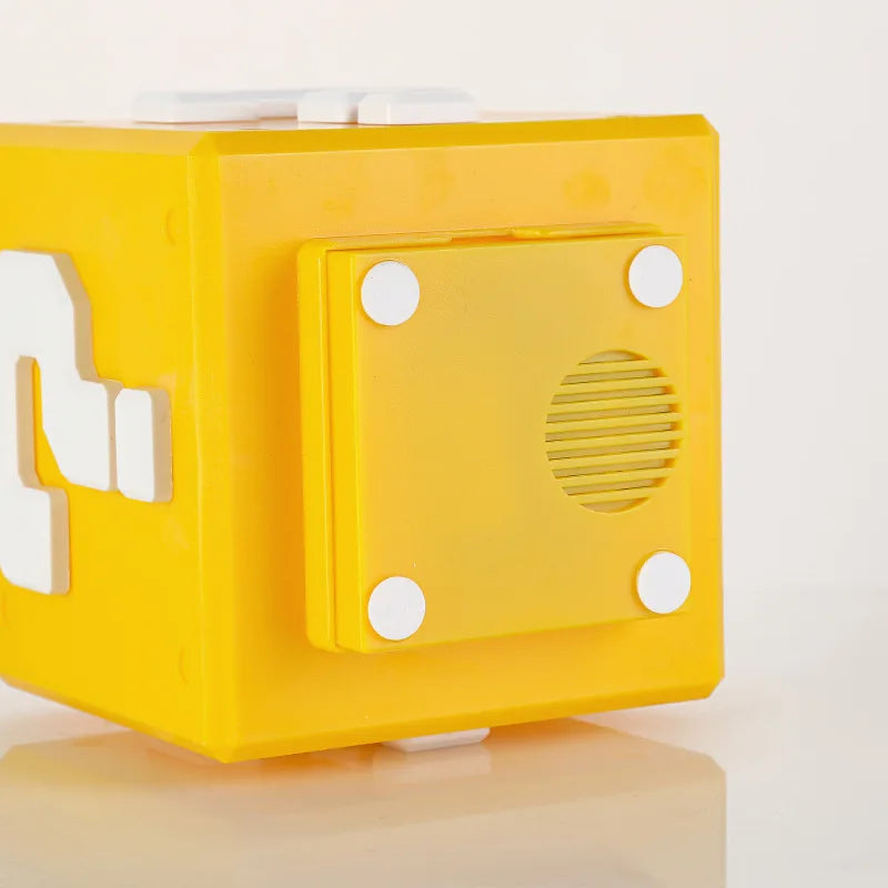 Close-up of the removable back panel of the cube, showing a round speaker grille and four white corner pads