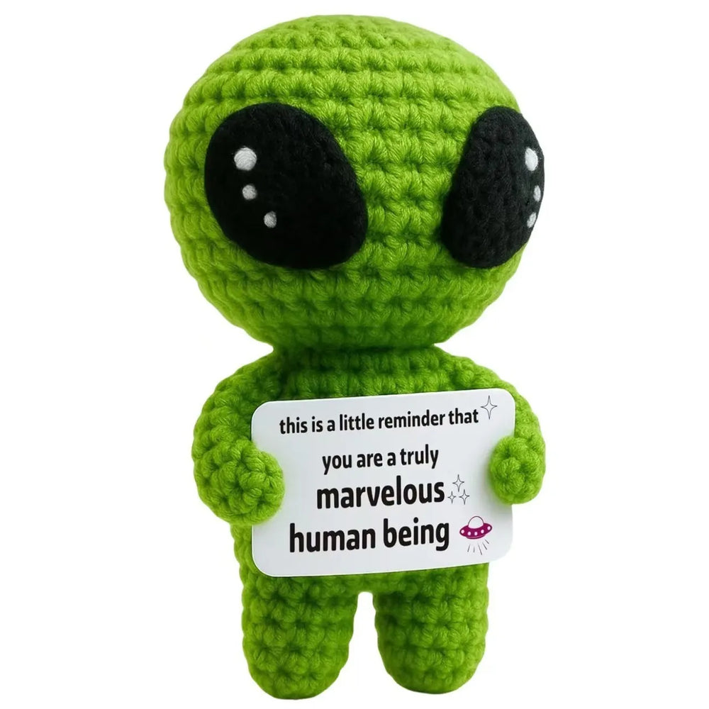Crochet positive affirmation doll holding an encouragement card