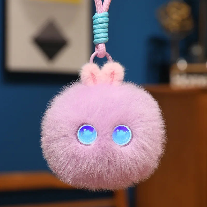 Lilac fluffy pom-pom charm with round blue light-up eyes, hanging from its cord