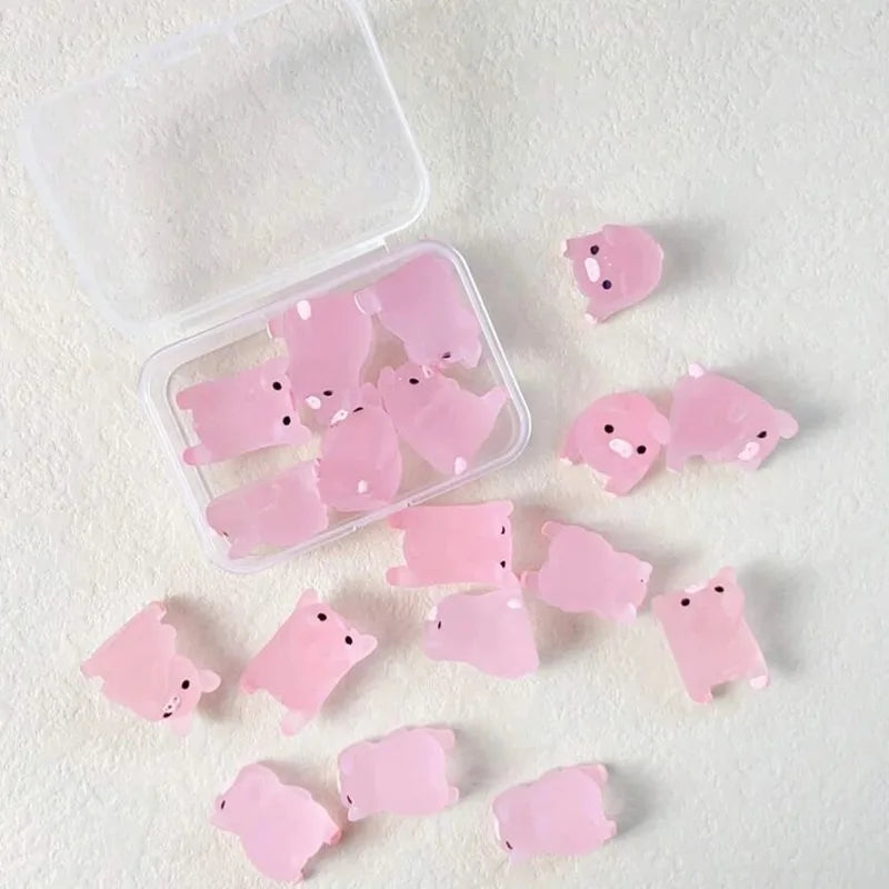 Clear box of mini pigs with several tipped out