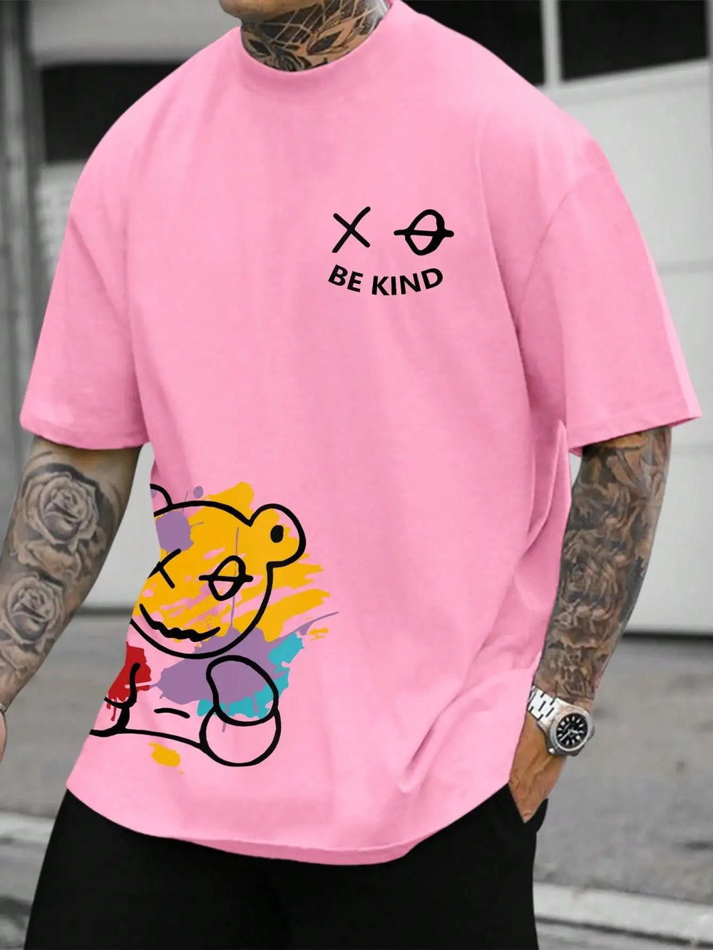 Pink cotton tee printed with a graffiti bear and the words BE KIND