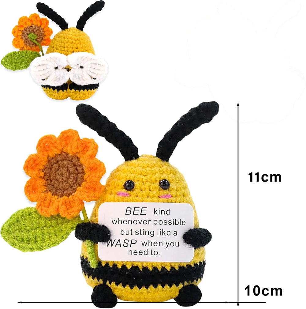 Crochet positive affirmation doll holding an encouragement card