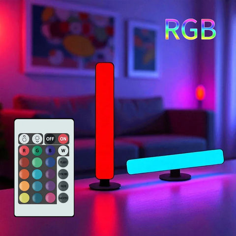 A red light bar standing upright and a cyan one lying flat, colouring a dark living room wall, with the remote handset alongside