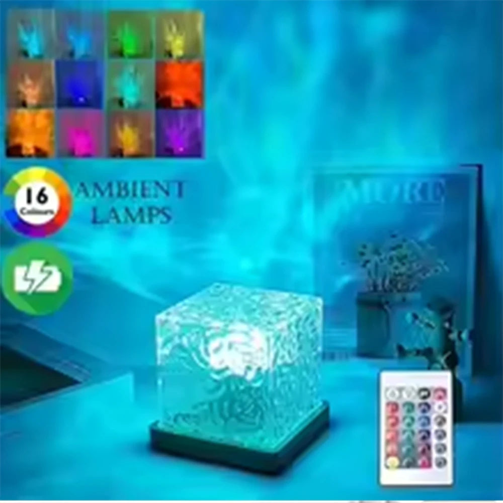 Cube lamp glowing teal on a shelf beside books and a plant