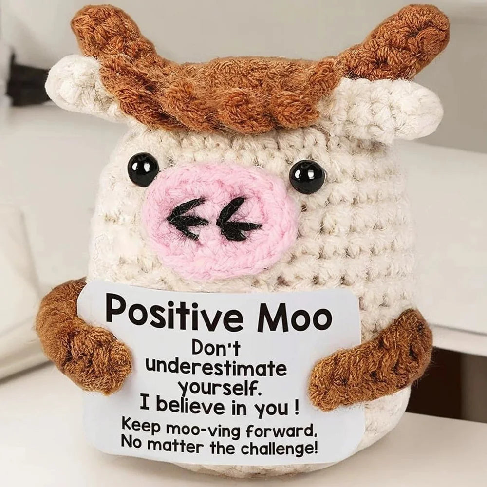 Crochet positive affirmation doll holding an encouragement card