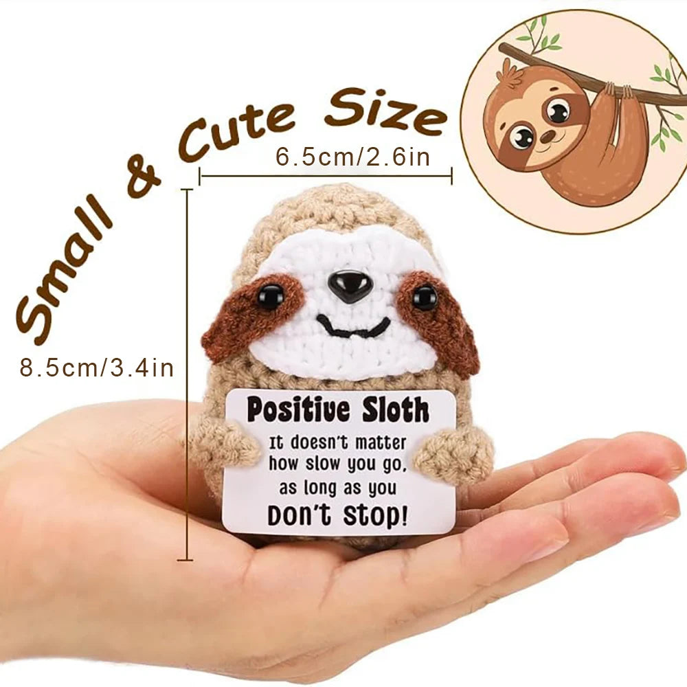 Crochet positive affirmation doll holding an encouragement card