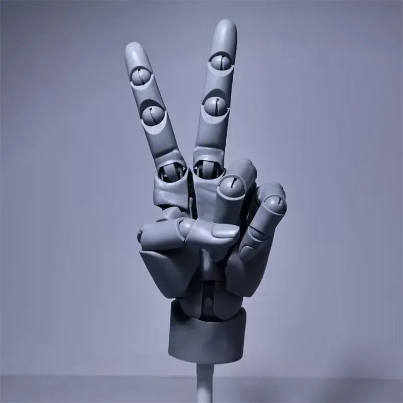 Grey poseable hand model raised in a peace sign on its stand