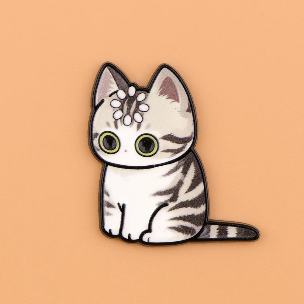 Silver tabby cat magnet with dark stripes and a ring of dots on its head