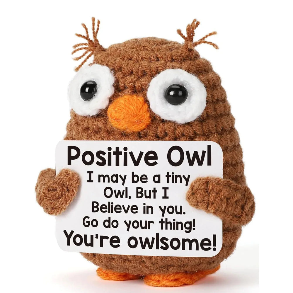 Crochet positive affirmation doll holding an encouragement card
