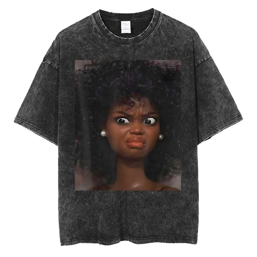 Washed charcoal oversized tee printed with a close-up of a dark-skinned doll with an afro and pearl earrings pulling a hard grimace