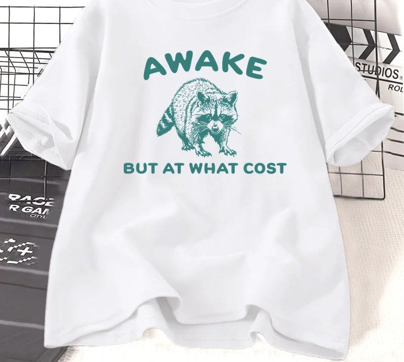 White cotton tee printed with a teal engraved raccoon and the words awake but at what cost