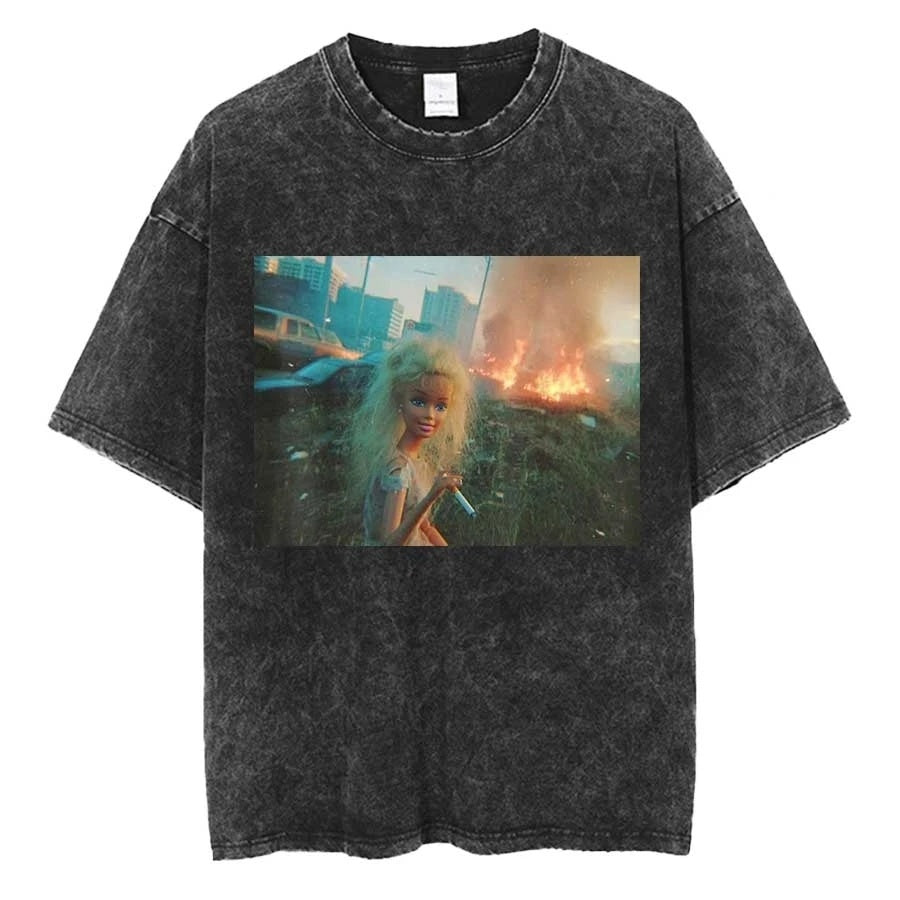 Washed charcoal oversized tee printed with a blonde doll standing at a roadside holding a cigarette, a city street burning behind her
