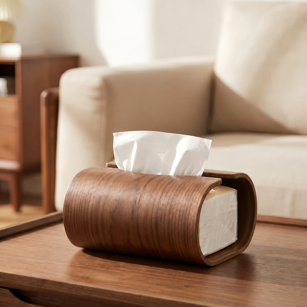 Curved walnut wood tissue box on a wooden table